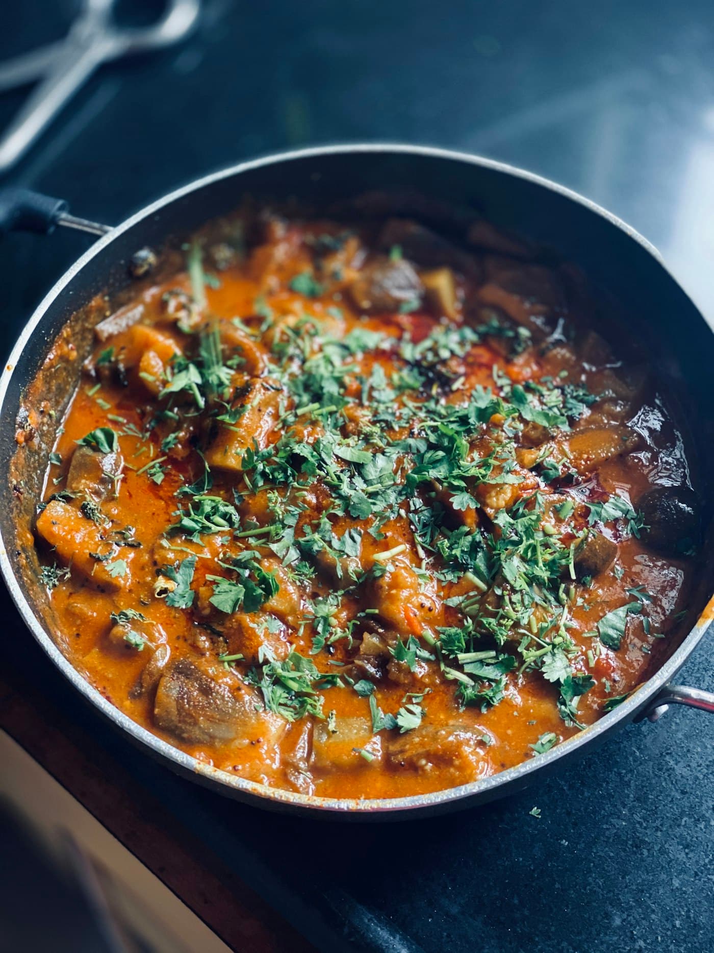 Vegetable curry in a pan with fresh coriander