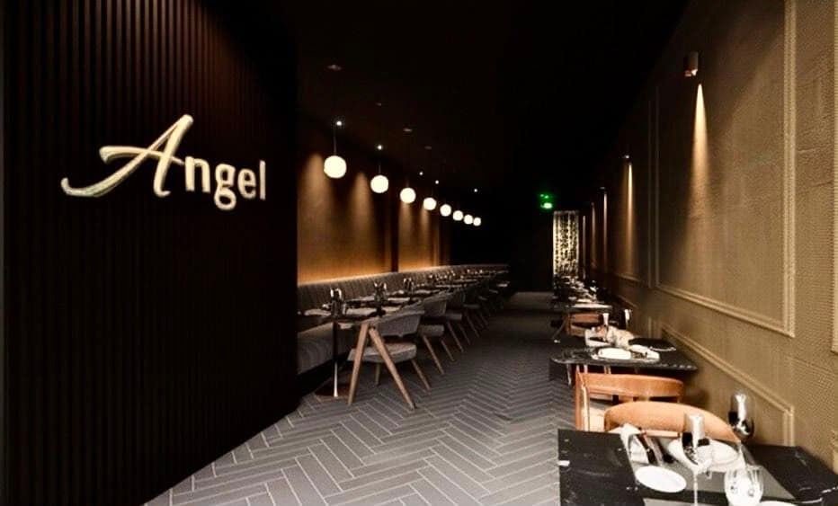 Angel's new dining room: the gold script sign, a long banquette and pendant lights running down the room